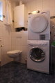 Das G&auml;ste WC der linken H&auml;lfte mit Blick auf Waschmaschine und Trockner